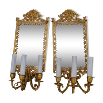 Pair of wall lights with mirror backgrounds with 3 arms of lights in chiseled and gilded bronze. framing decorated with foliage and masks. louis xiv style