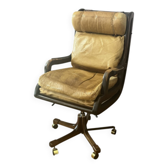 Vintage mahogany and havana leather office chair with wheels from around 1970.