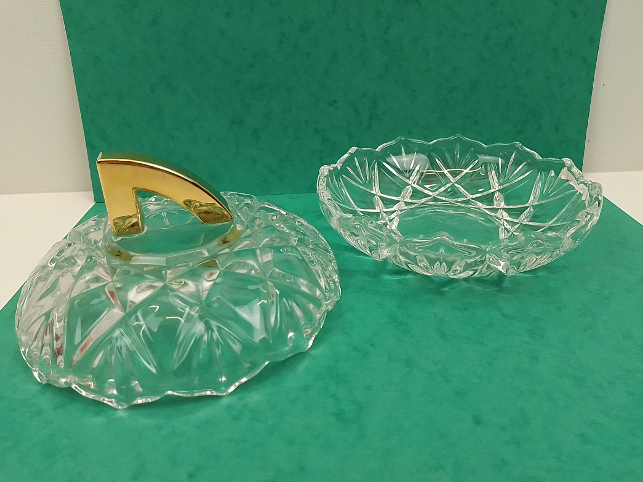 Round crystal box and a golden metal handle