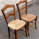 2 solid oak carved and rush-seated chairs in the Louis Philippe style, 19th century.