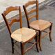2 solid oak carved and rush-seated chairs in the Louis Philippe style, 19th century.