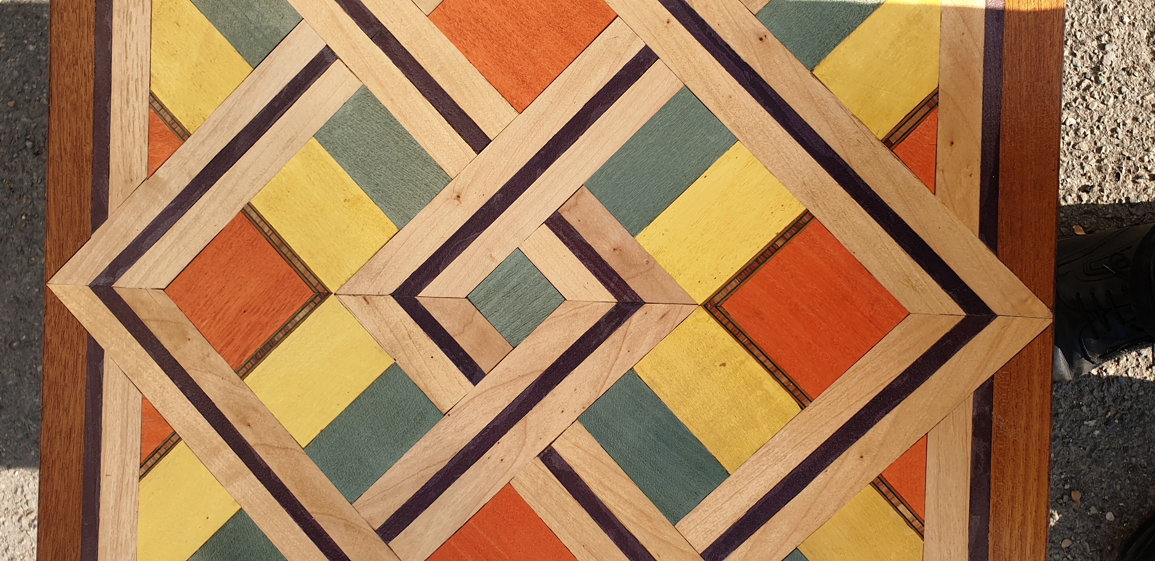 Wooden table with geometric decoration