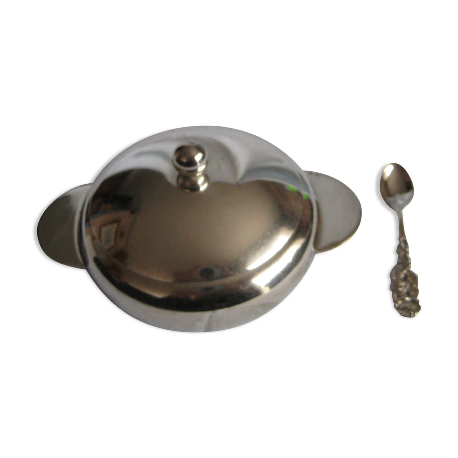 silver metal sugar and silver sugar spoon.