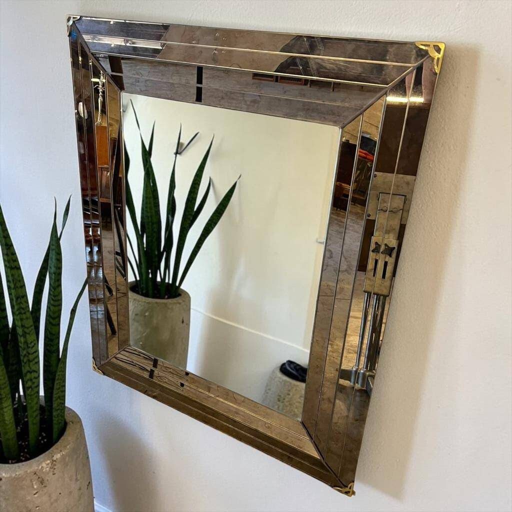 Vintage gold wall mirror with a smoked mirror border.