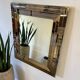 Vintage gold wall mirror with a smoked mirror border.
