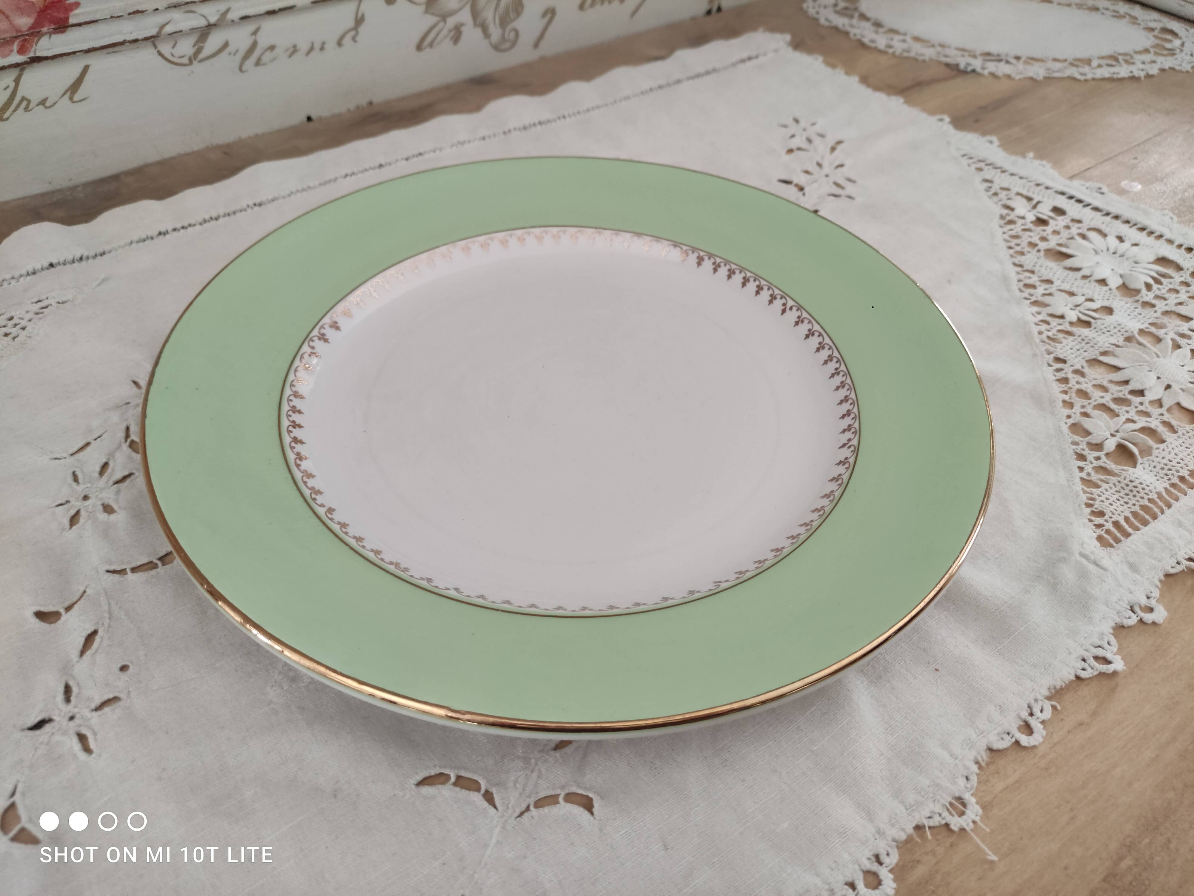 Round plate with aqua green rim and golden frieze, Cafés Lemaire.