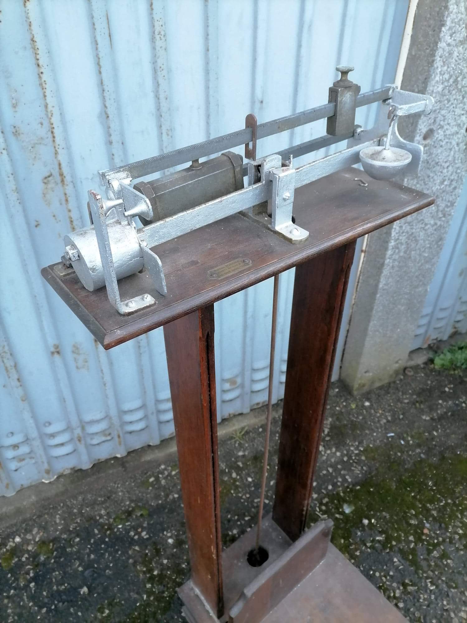 Old scale at pharmacy wood house rongier weighs person