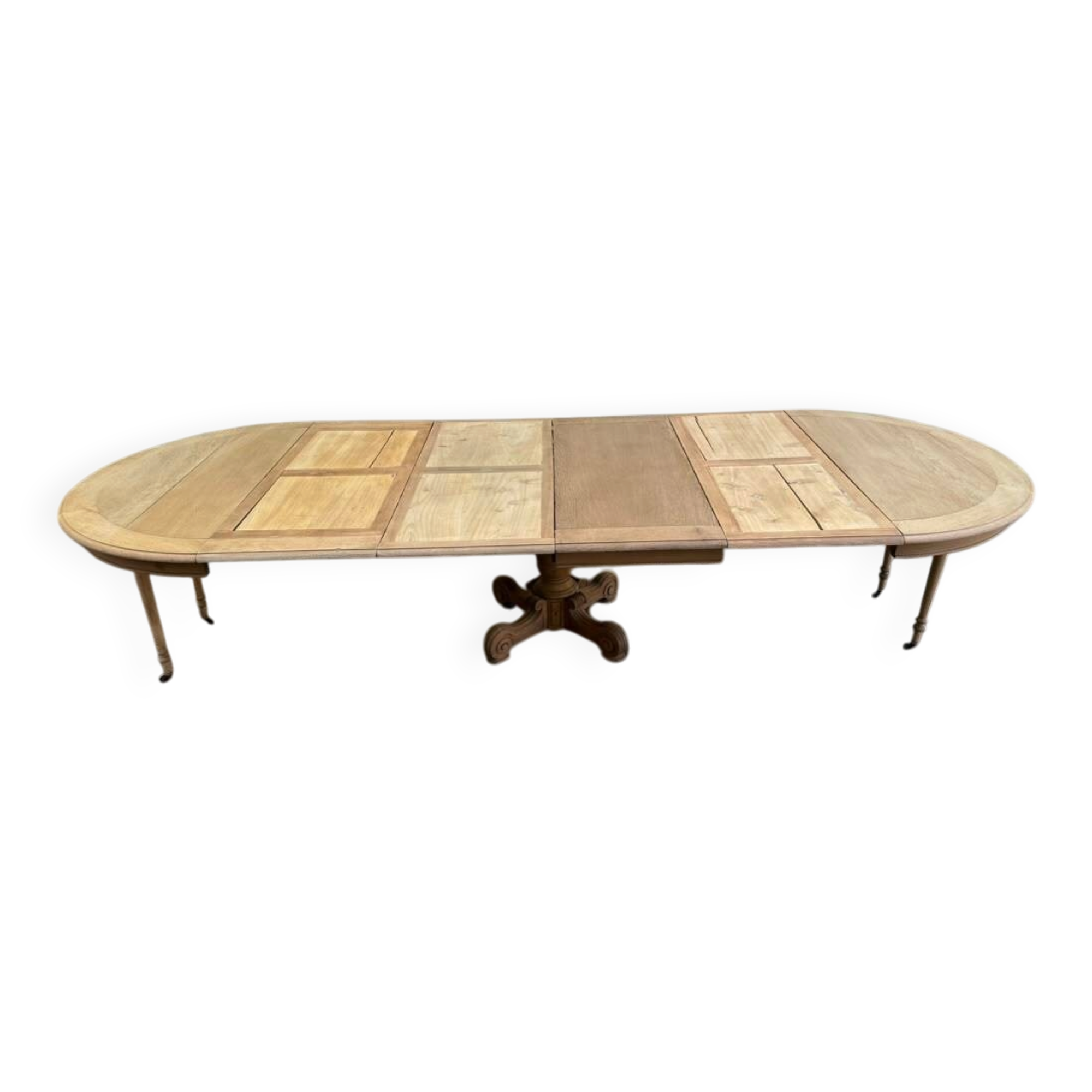 Round dining table with a central pedestal, stripped raw oak, 4 extensions, 19th century.