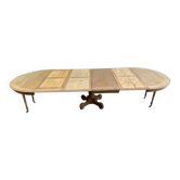 Round dining table with a central pedestal, stripped raw oak, 4 extensions, 19th century.