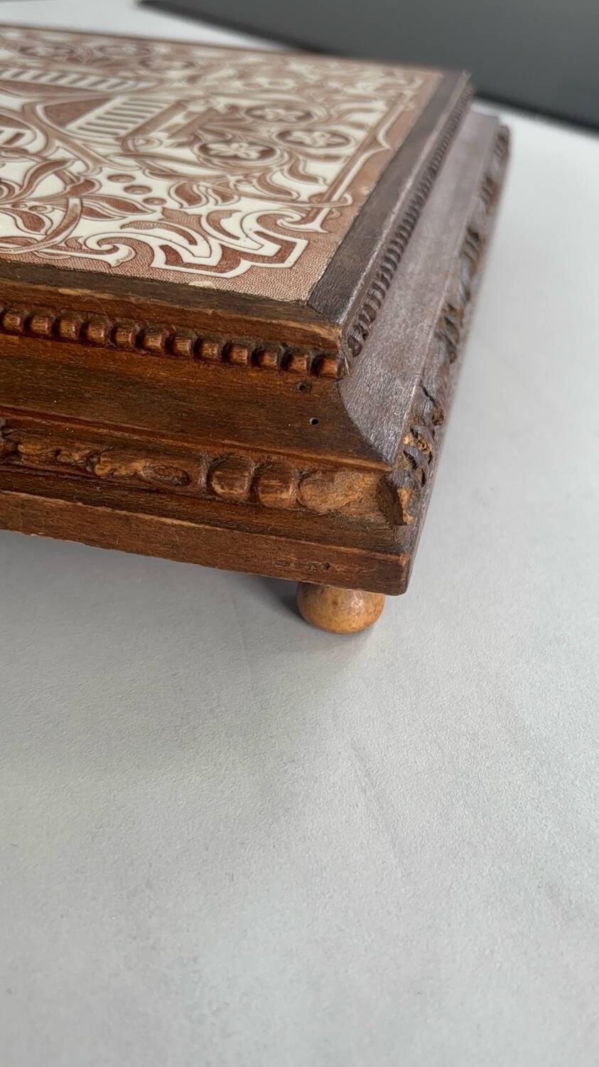 Vintage wooden and antique earthenware trivet, brown tile design