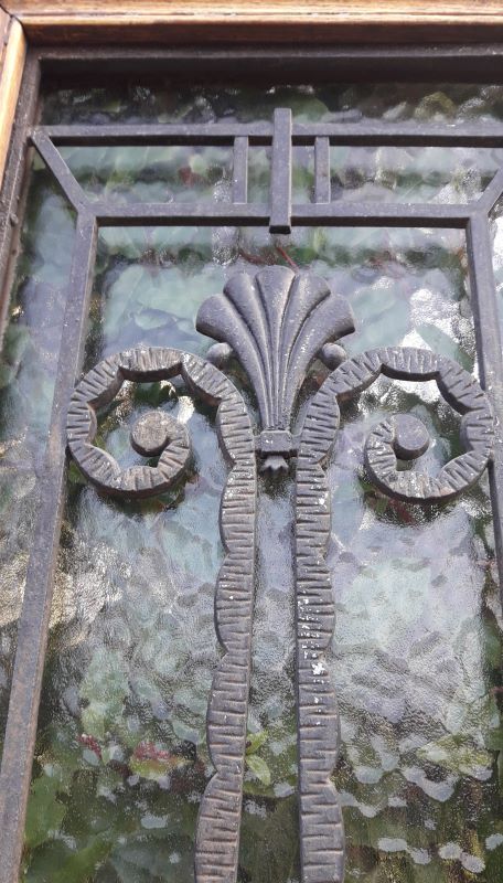 Oak entrance door and its frame and transom, wrought iron gates