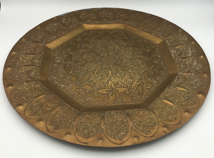 Oriental brass tray with chiseled decoration of arabesques and flowers