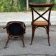 4 bistro chairs with curved wooden backs and cross braces / Crossback