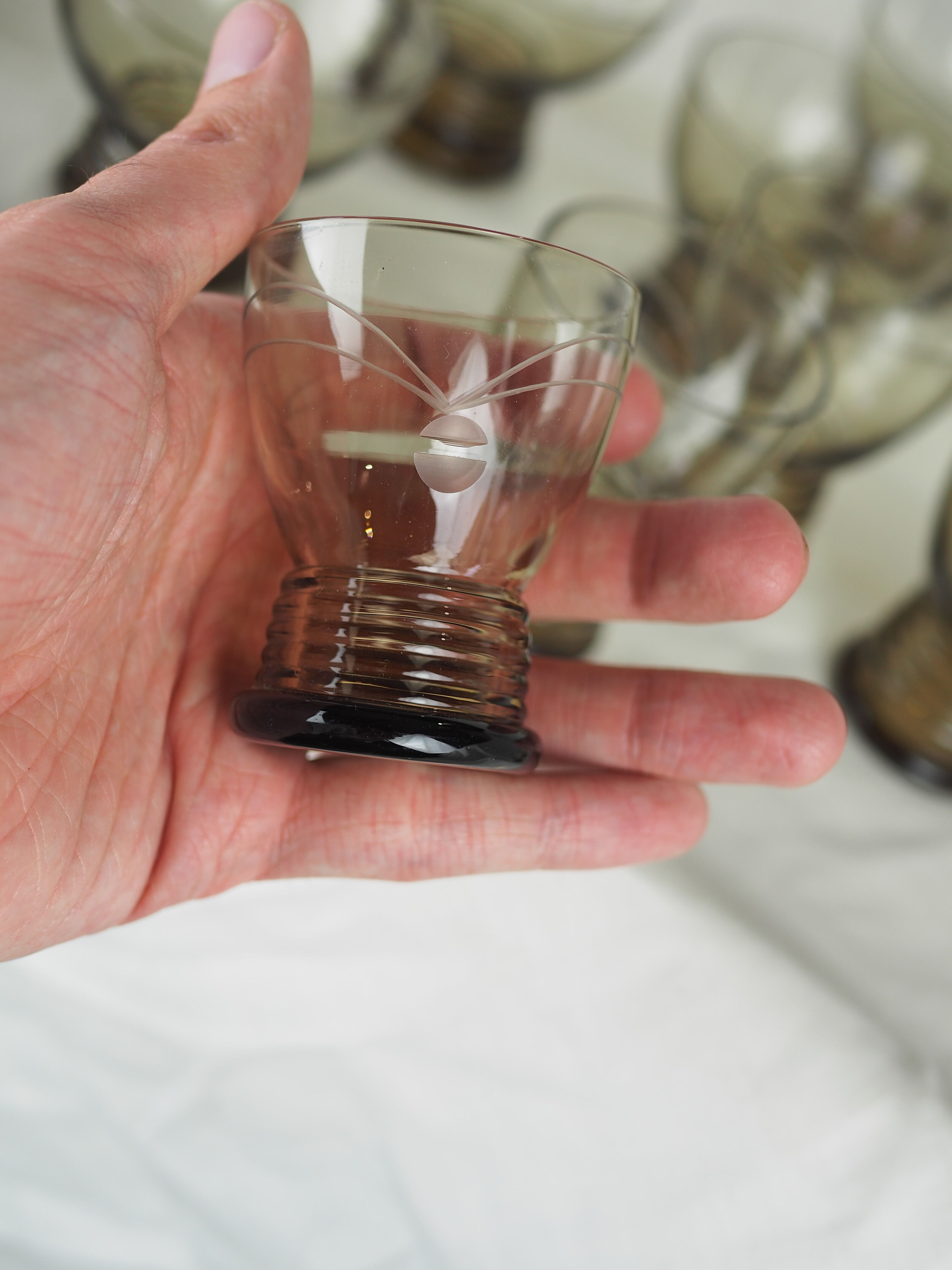 Set of 17 black smoked glasses on geometric engraving stand - 70s