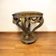 A round Louis XV style table in carved gilt beechwood with a black marble top