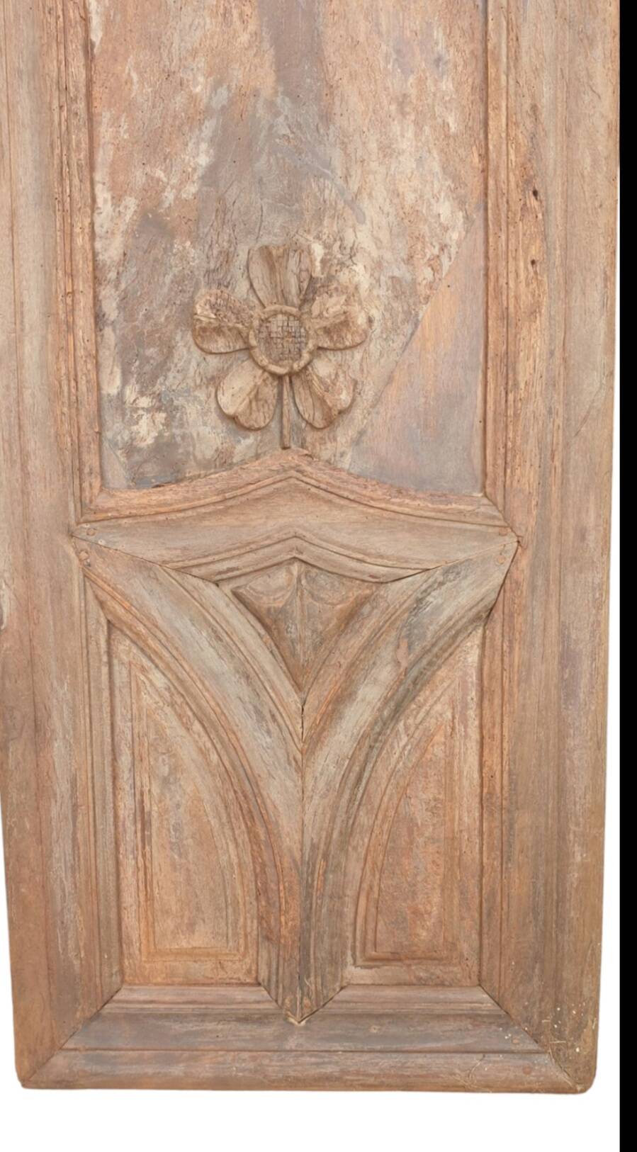 Paneled and carved wooden cupboard door