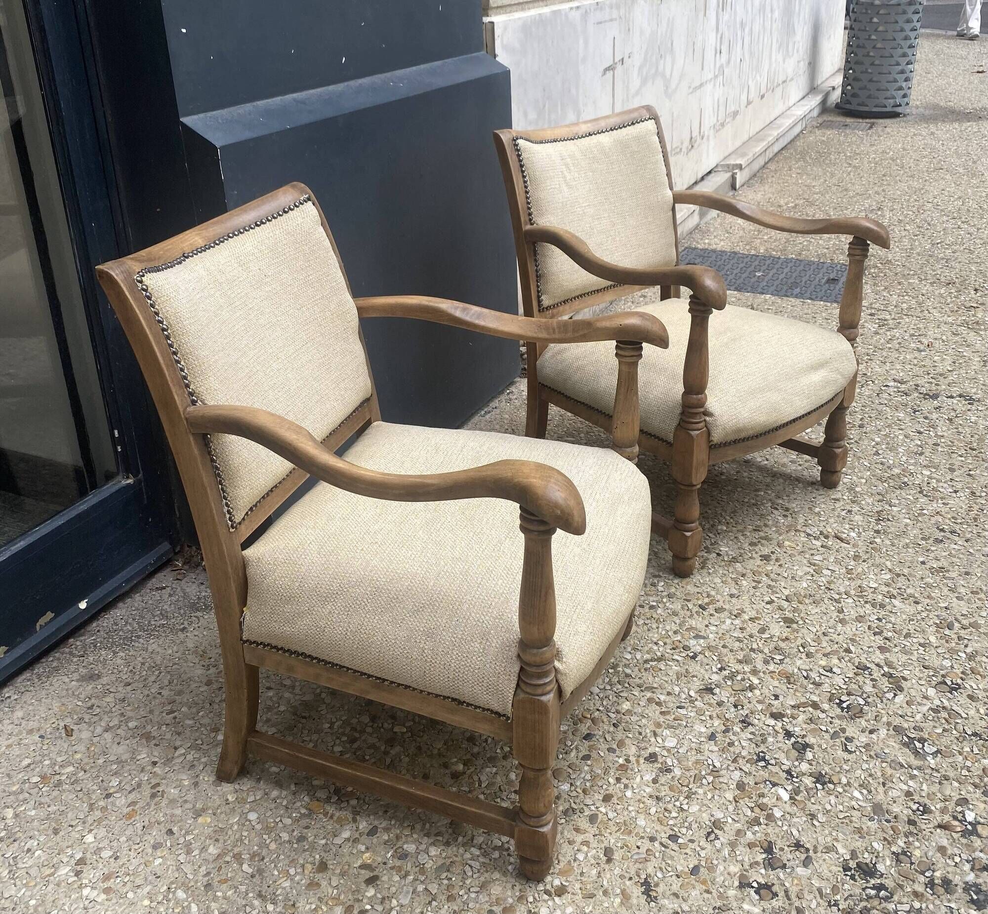 Pair of wooden and cream fabric armchairs