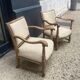Pair of wooden and cream fabric armchairs
