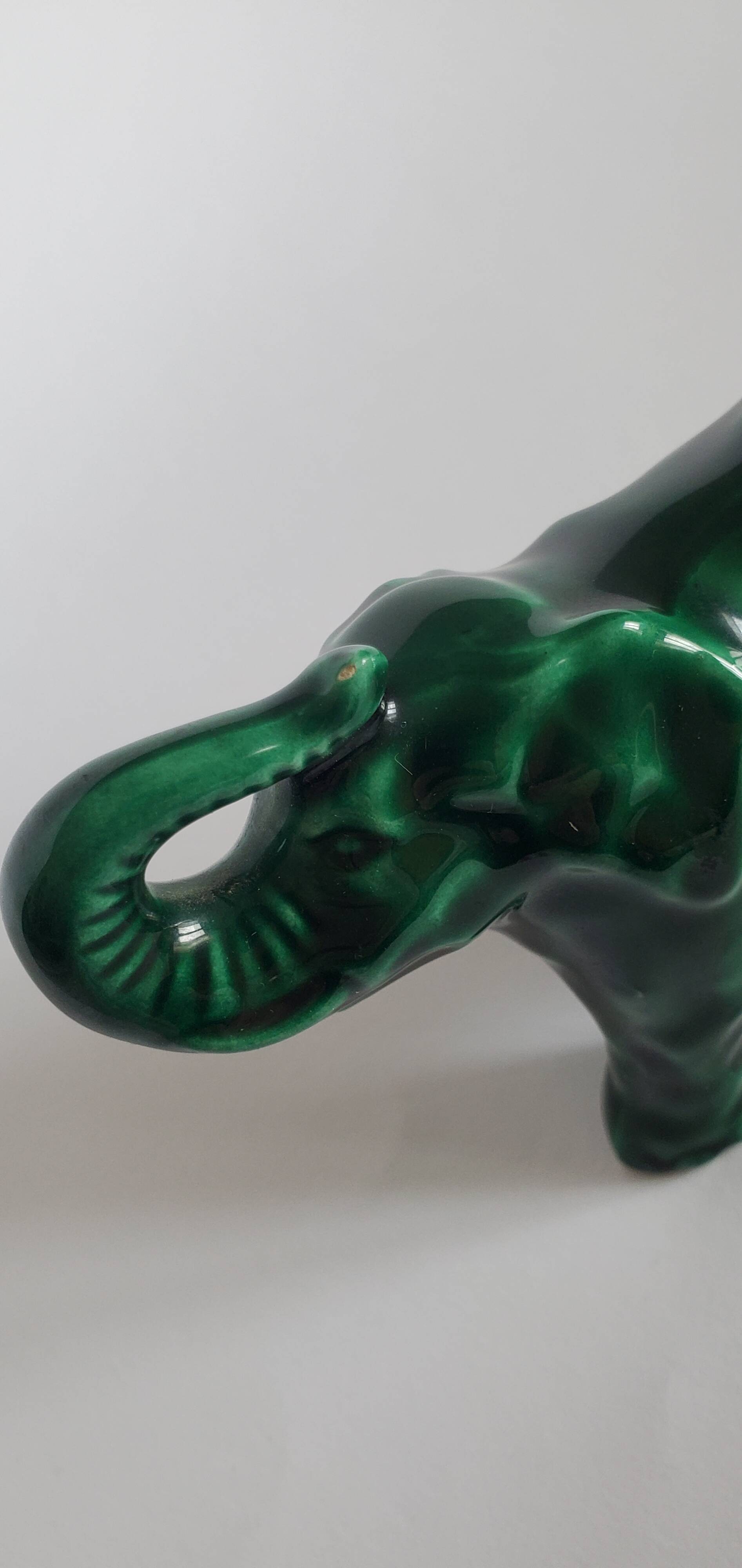 Small emerald green ceramic elephant.