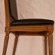 Antique Louis XVI style chair in solid wood and patinated leather.