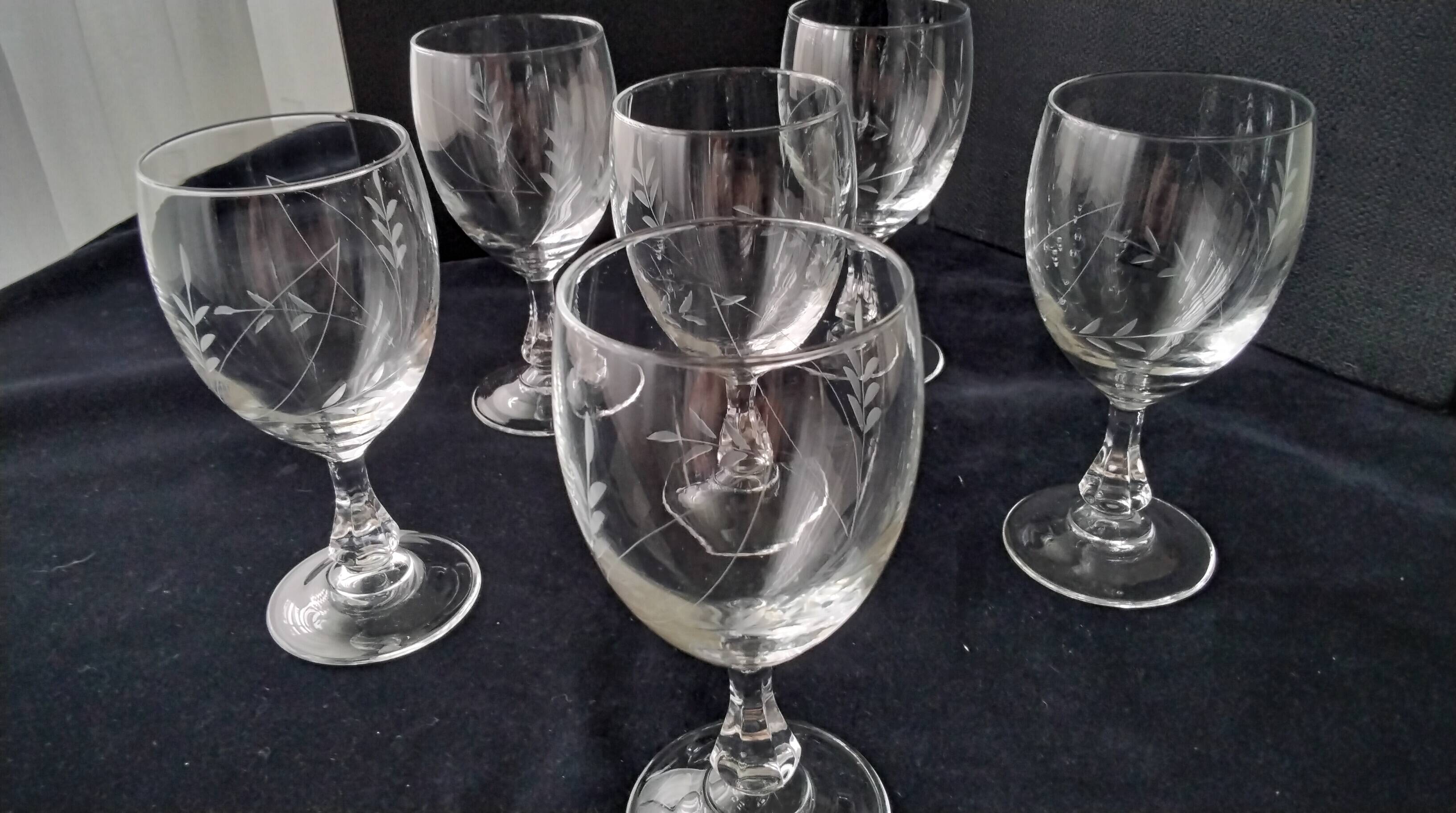 6 vintage wine glasses with baluster stems and engraved decoration on the bowl.