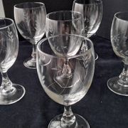 6 vintage wine glasses with baluster stems and engraved decoration on the bowl.