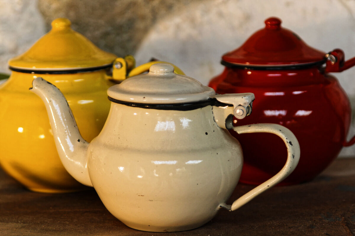 Trio of small enamelled teapots
