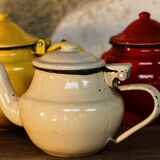 Trio of small enamelled teapots