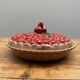 A trompe l’oeil strawberry pie dish