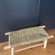 Natural wood bench and braided doum.