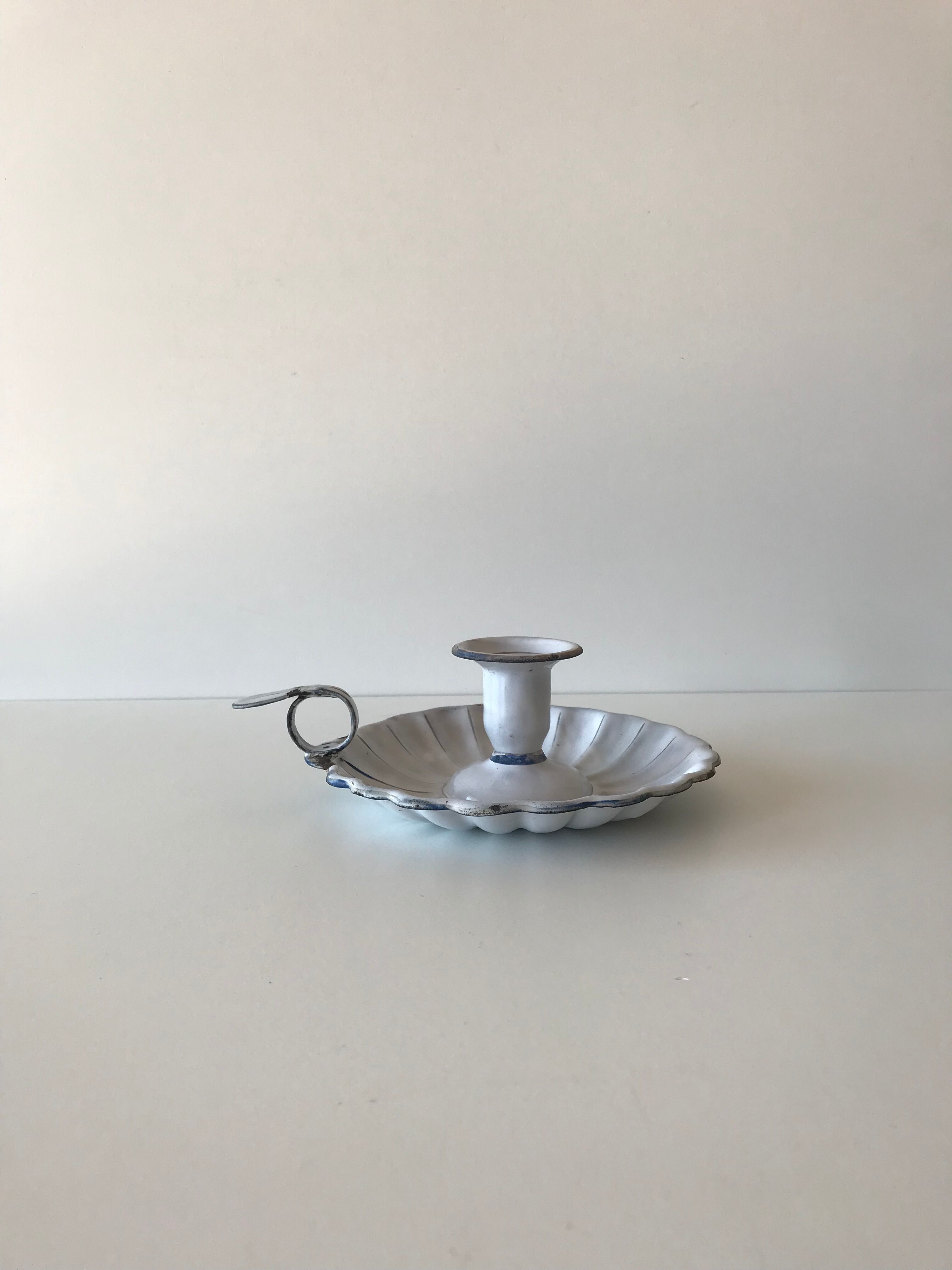 Candlestick in white enameled metal