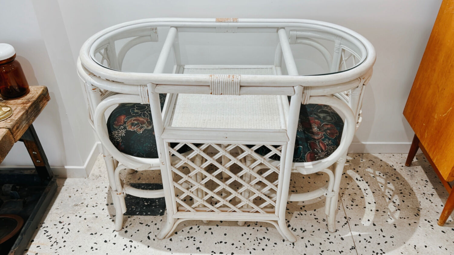 Rattan head-to-head table with vintage armchairs