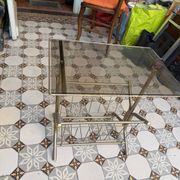 Vintage style side table with magazine holder, gold metal and glass top.