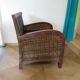 2 colonial-style armchairs in woven rattan and exotic wood