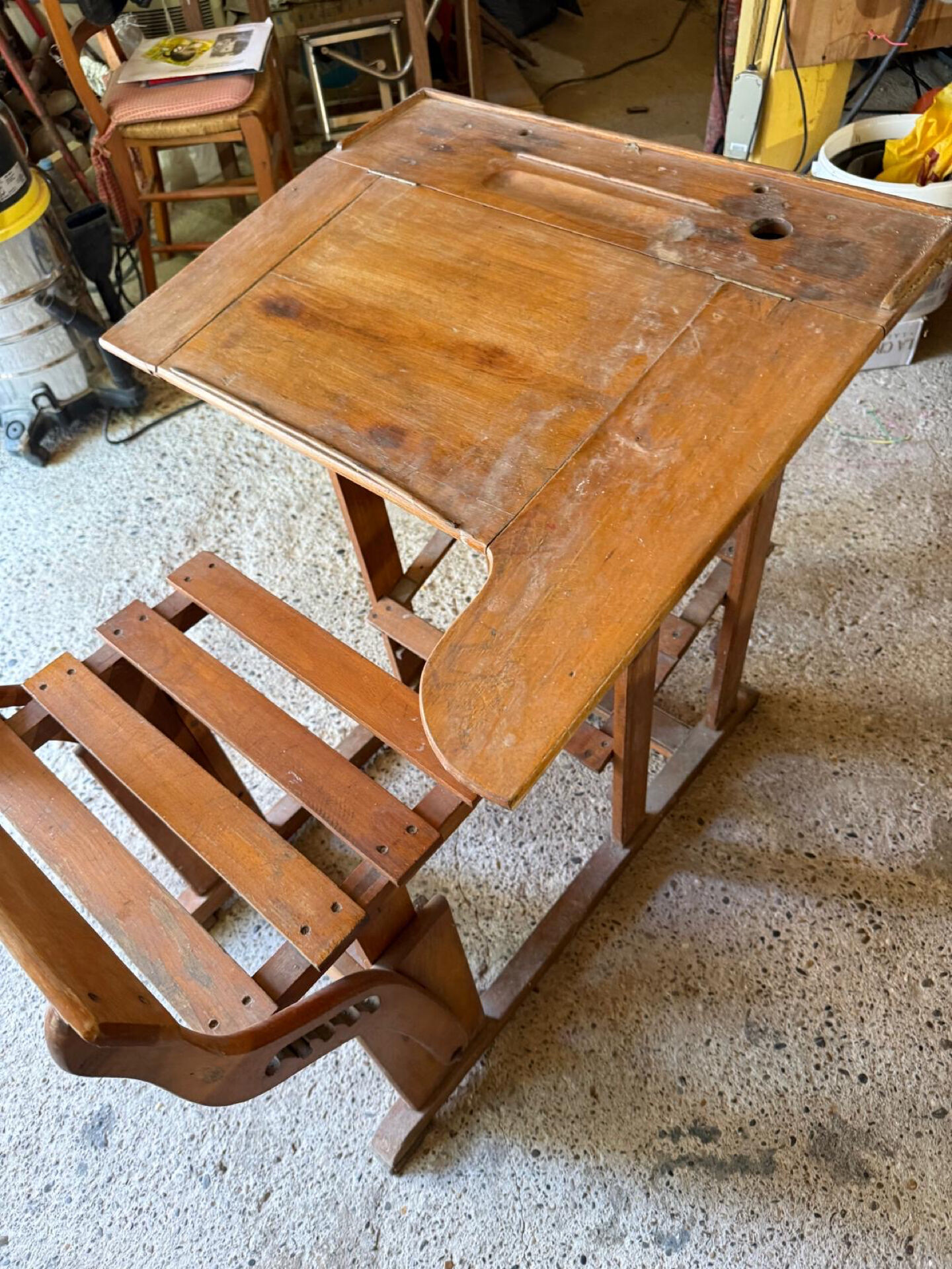 Old school desk with integrated adjustable seat.