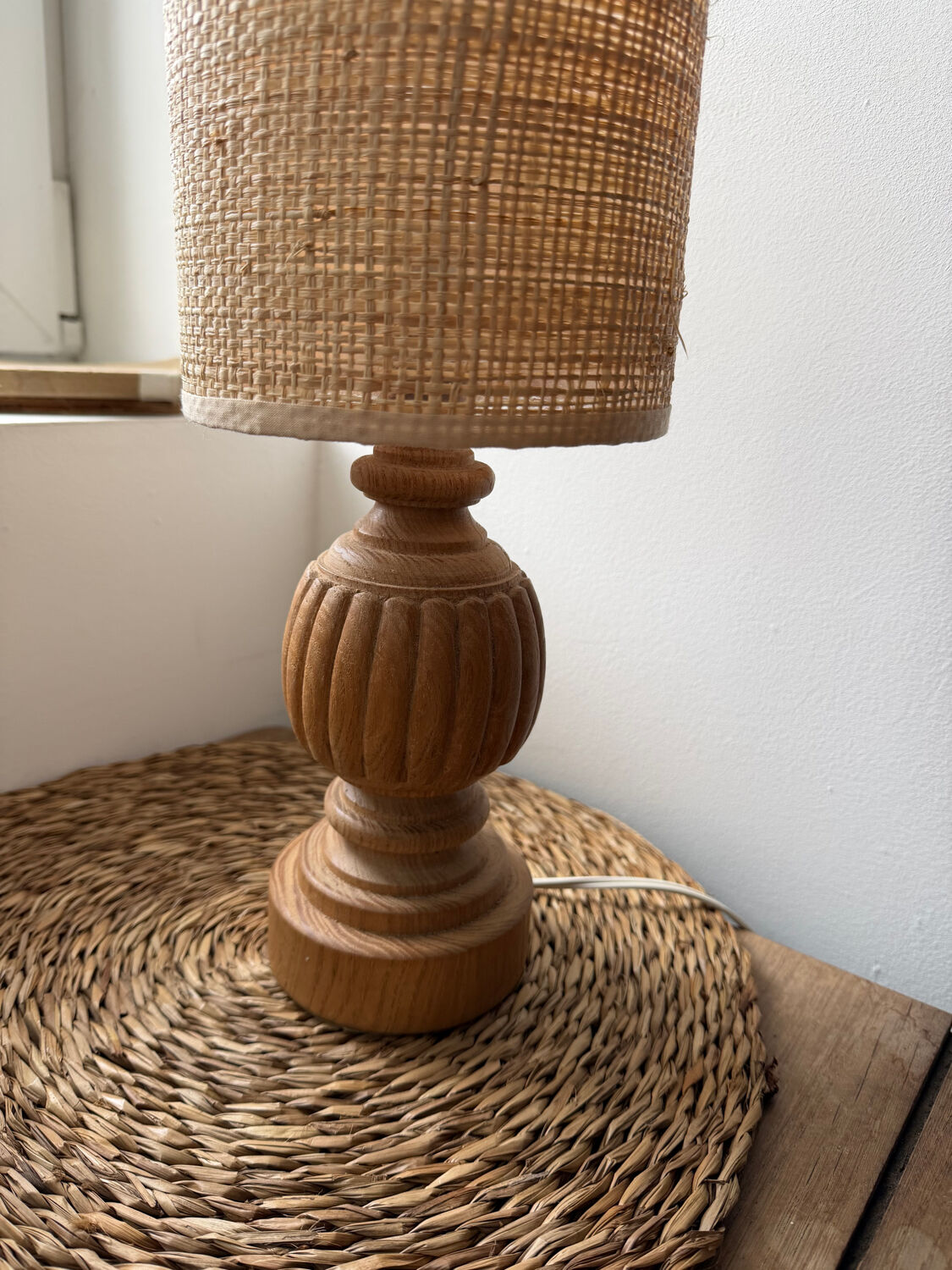 Antique table lamp with a carved wooden base.