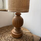Antique table lamp with a carved wooden base.