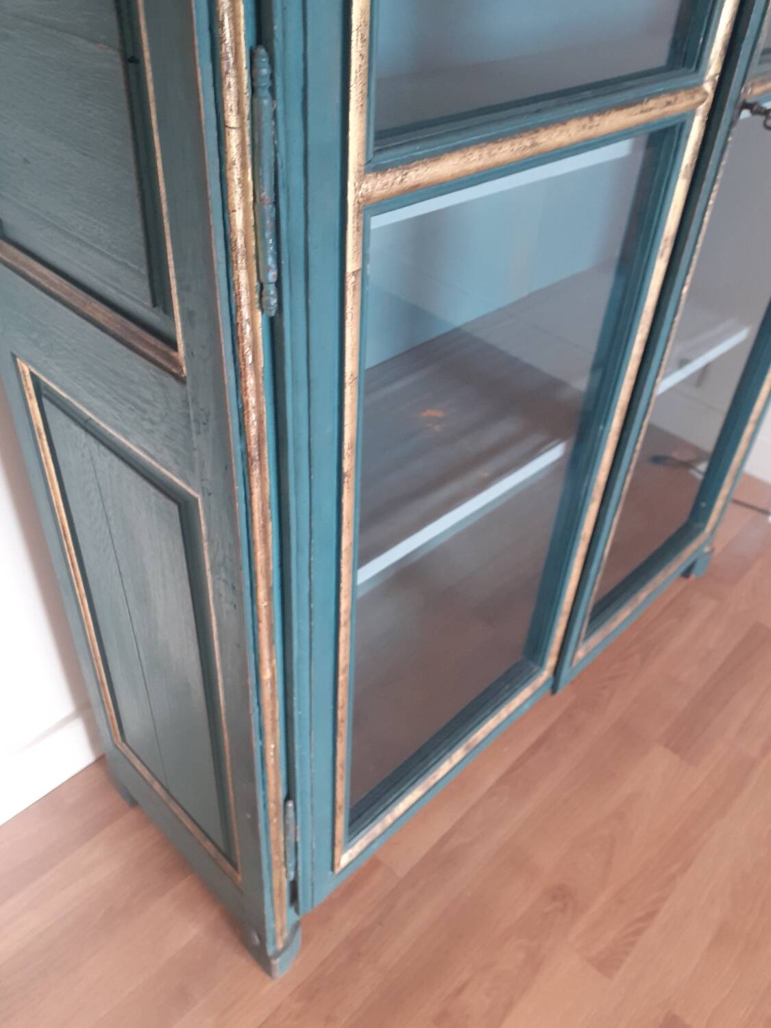 Glass-fronted cabinet in weathered green wood