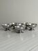 Set of 6 low footed bowls in mirror stainless steel.