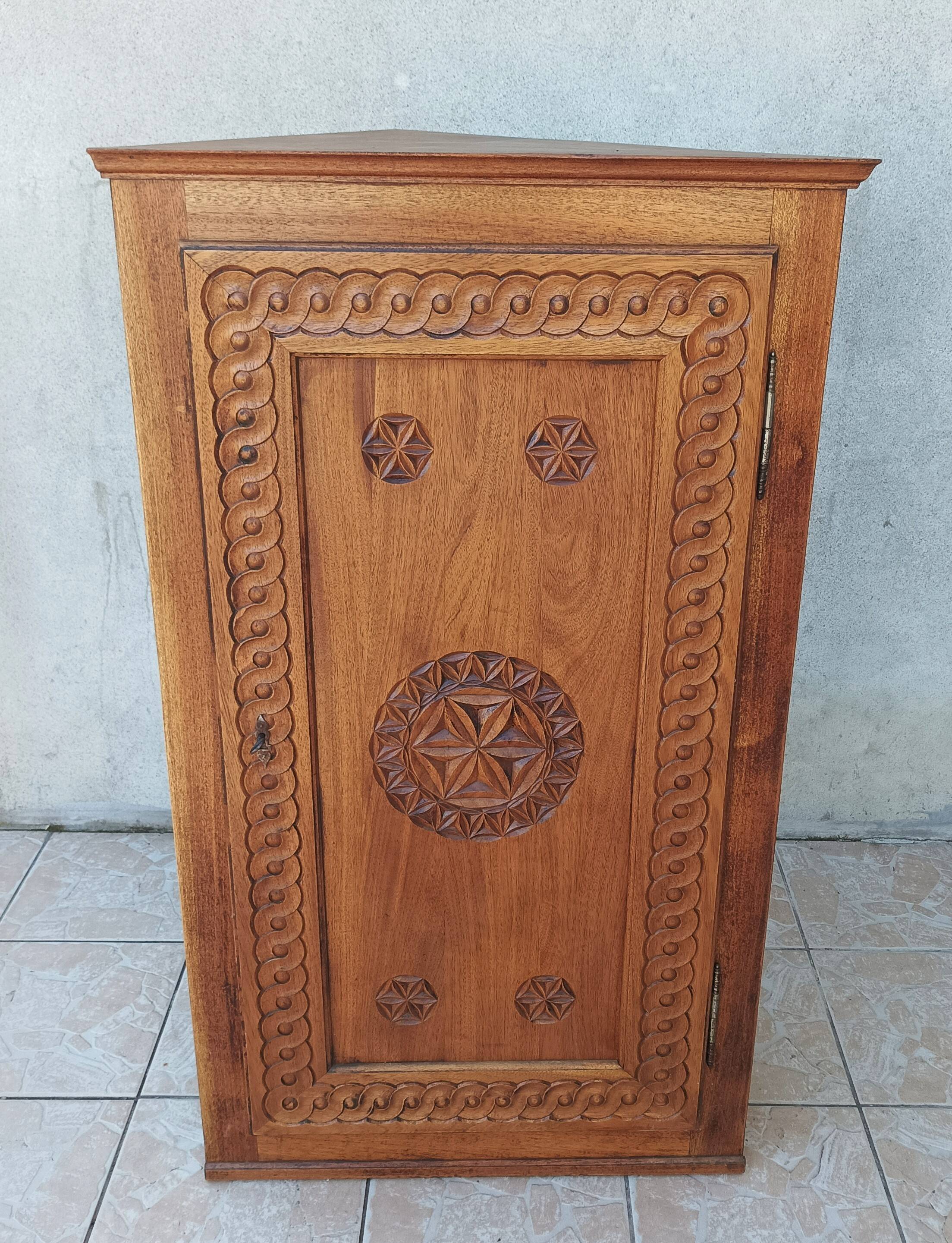 Corner cabinet in carved walnut, Savoyard style.