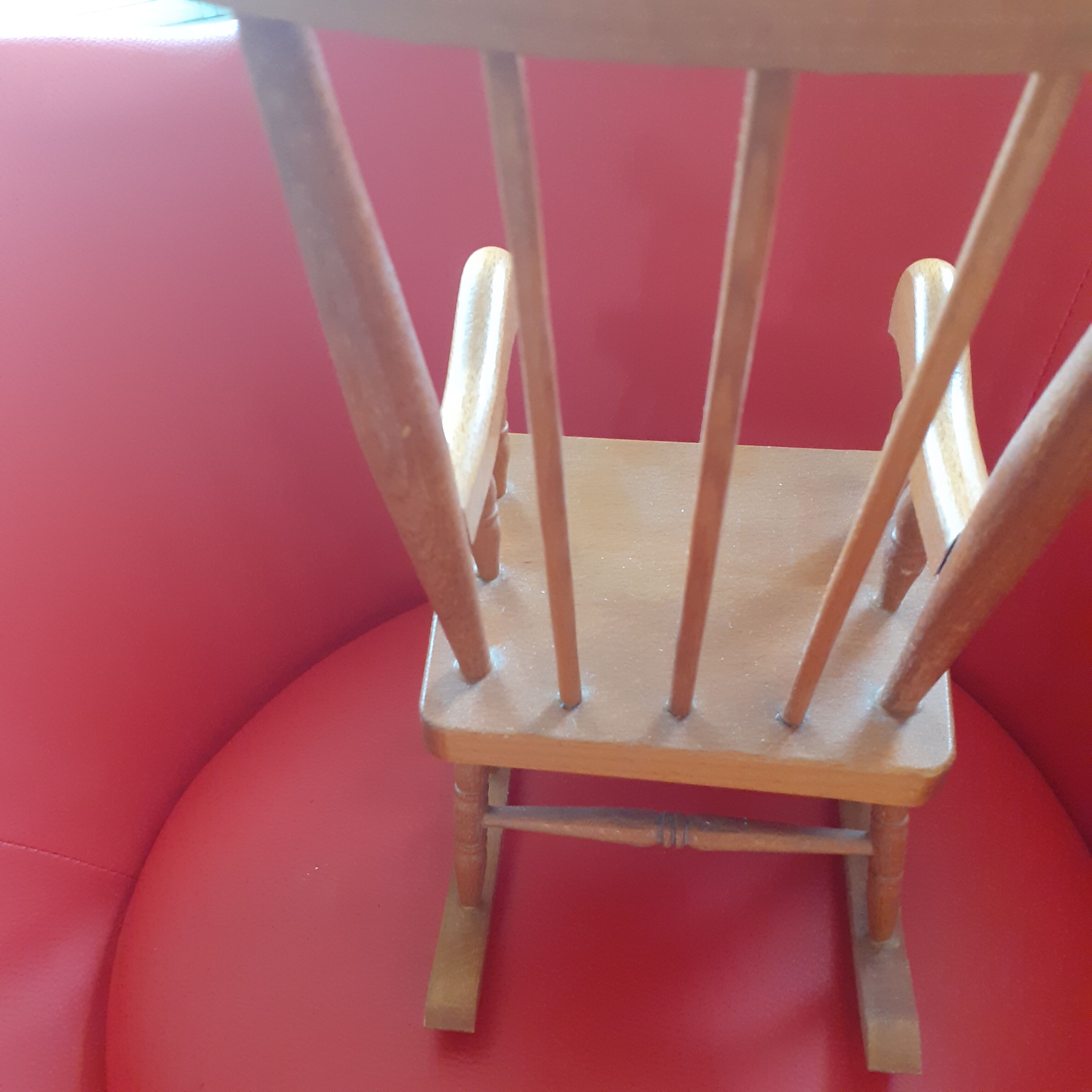 Toy wooden rocking chair.