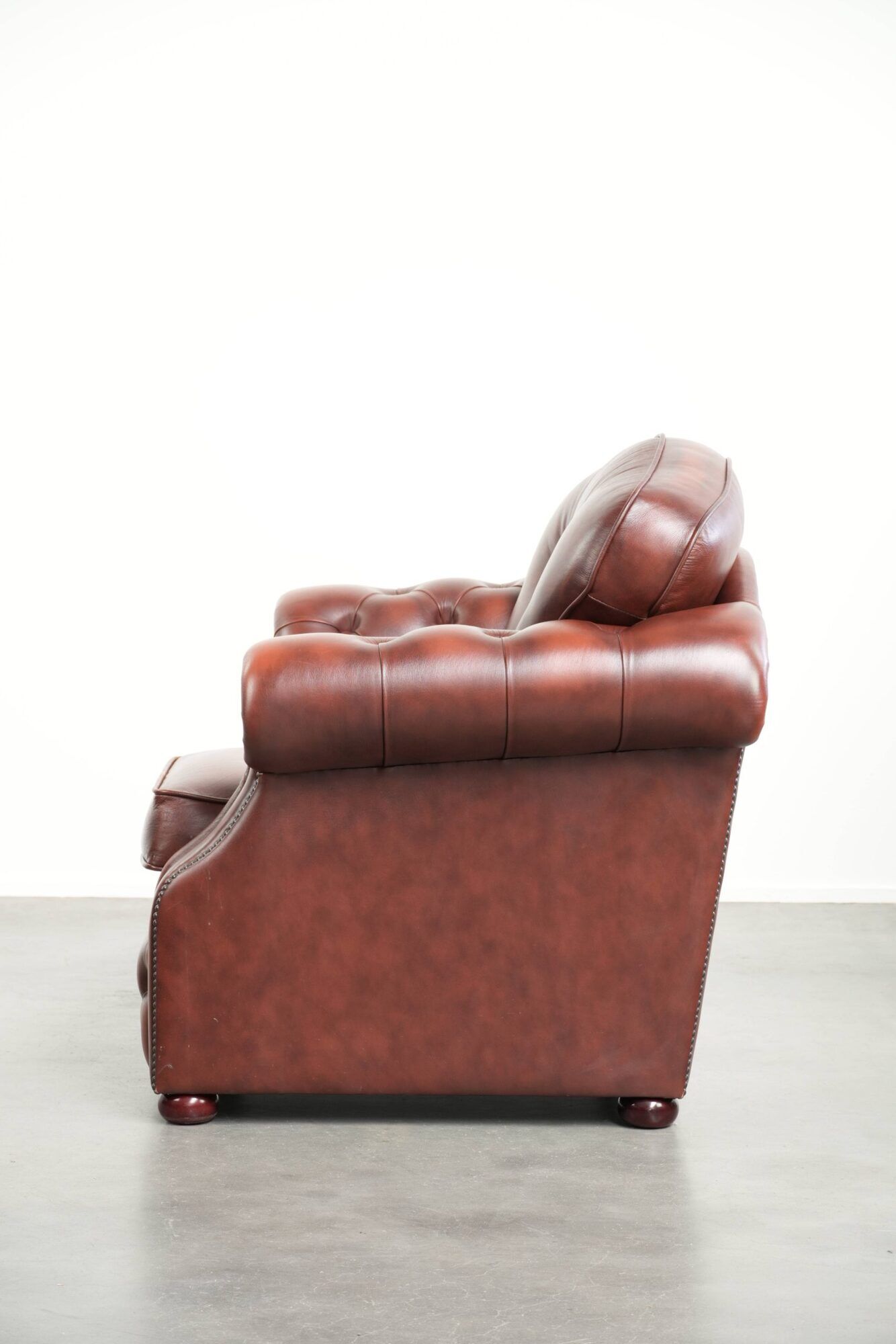 Brown cow leather Chesterfield armchair in a unique design