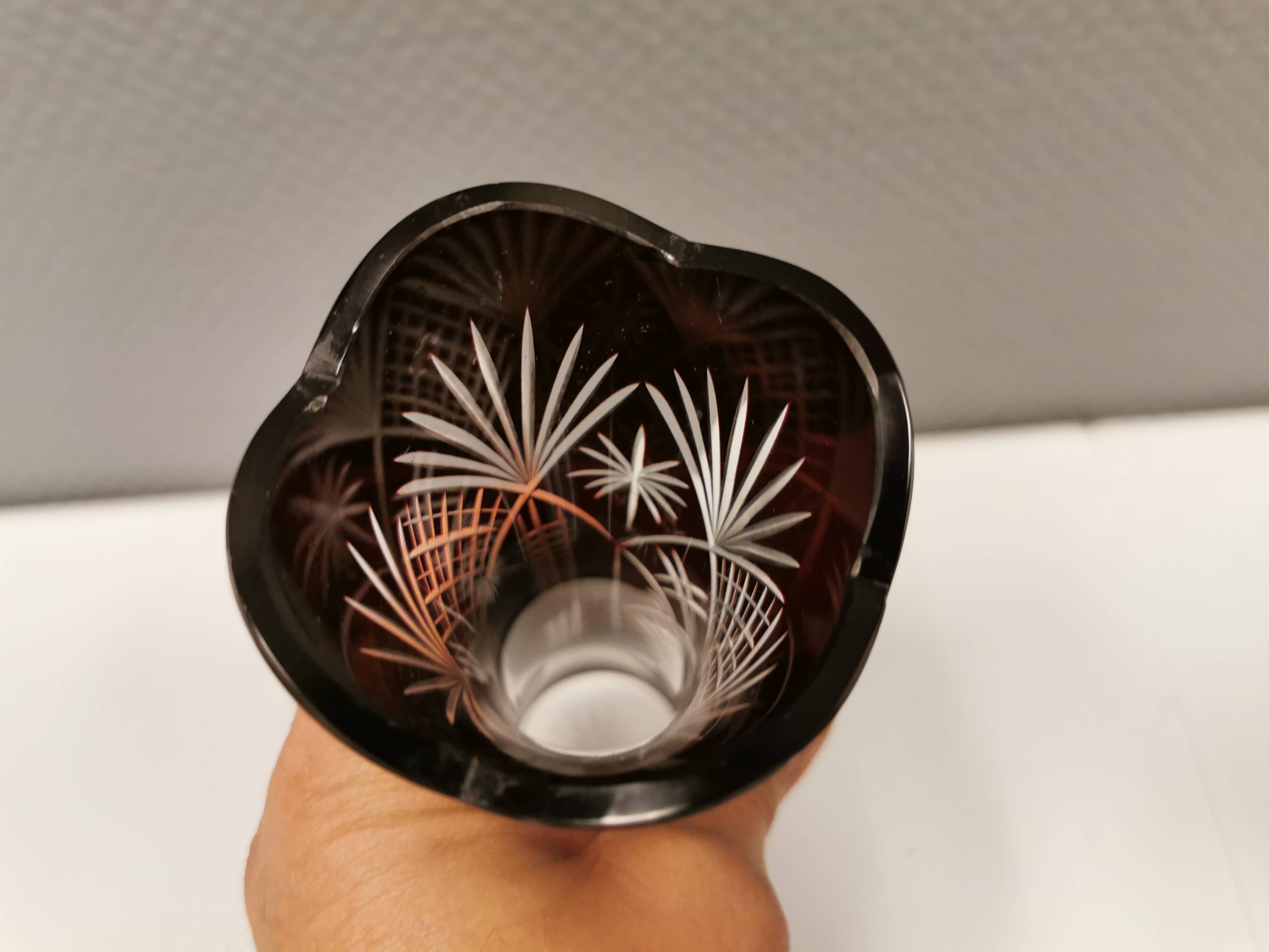 Crystal glass vase, in burgundy/reddish coloured glass with translucent details.