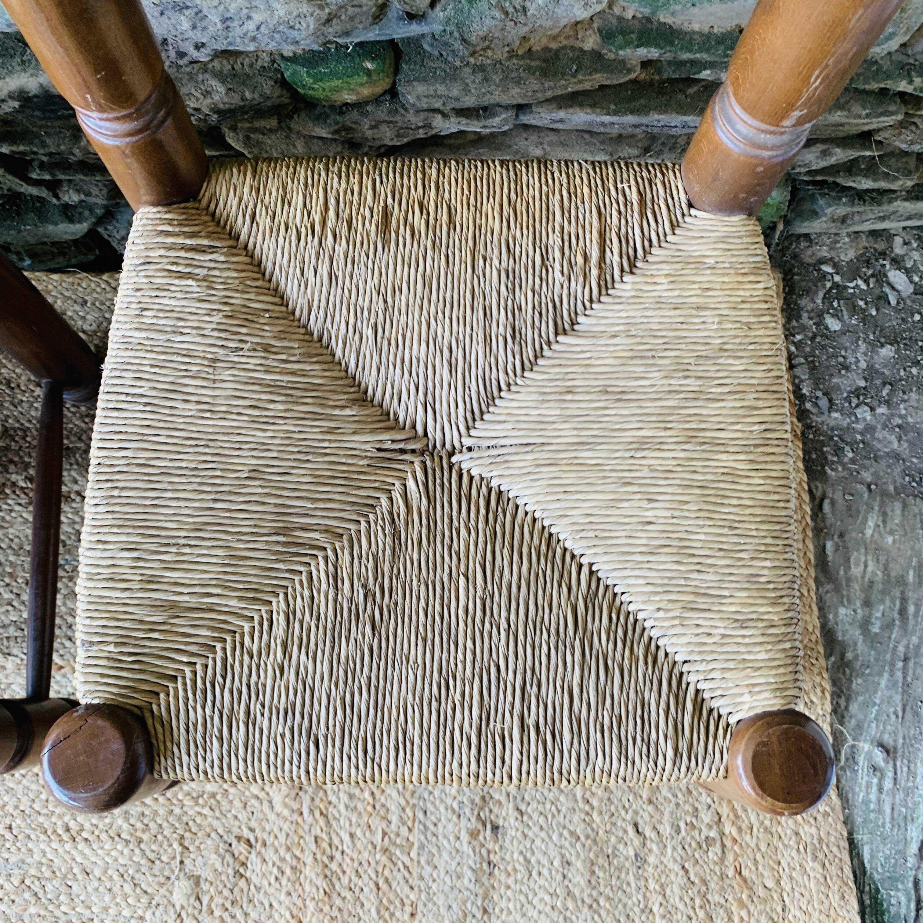 Set of 4 solid wood chairs with straw seats.