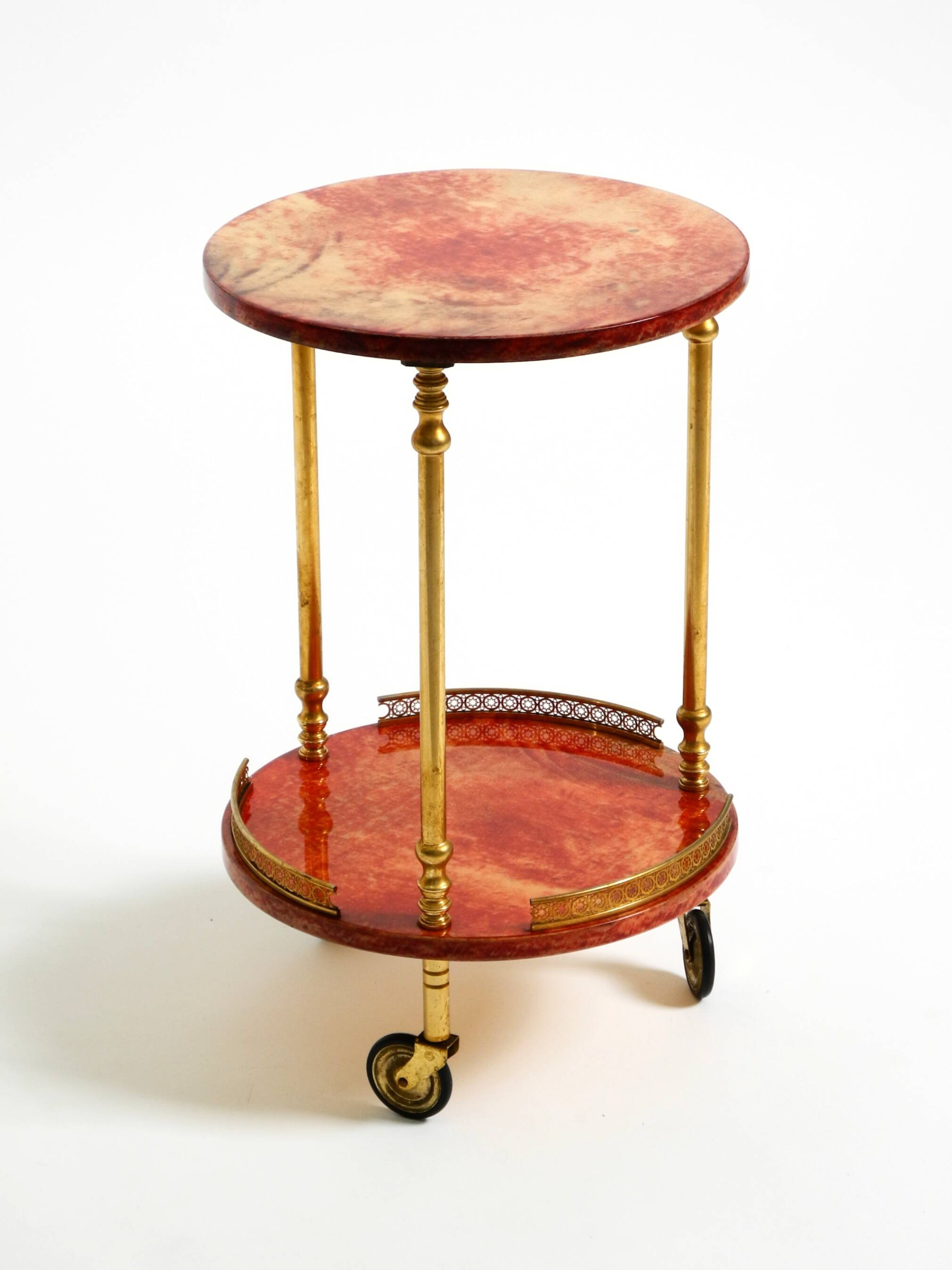 Round, small 1960s Aldo Tura serving or bar trolley in red goatskin leather