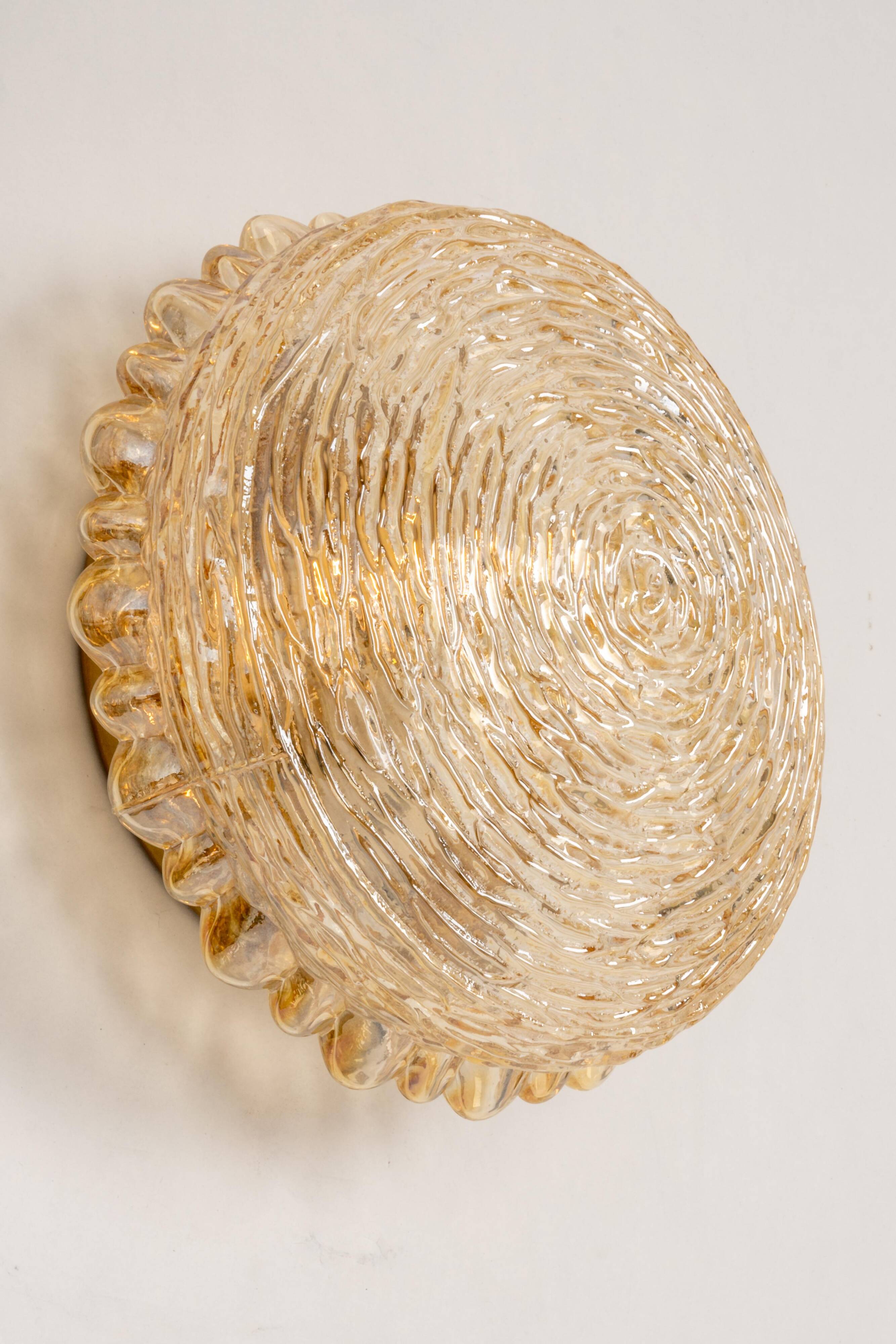 Amber glass wall sconces in the shape of a fingerprint, Germany, 1970s.