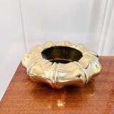 Golden brass ashtray with bamboo decoration.