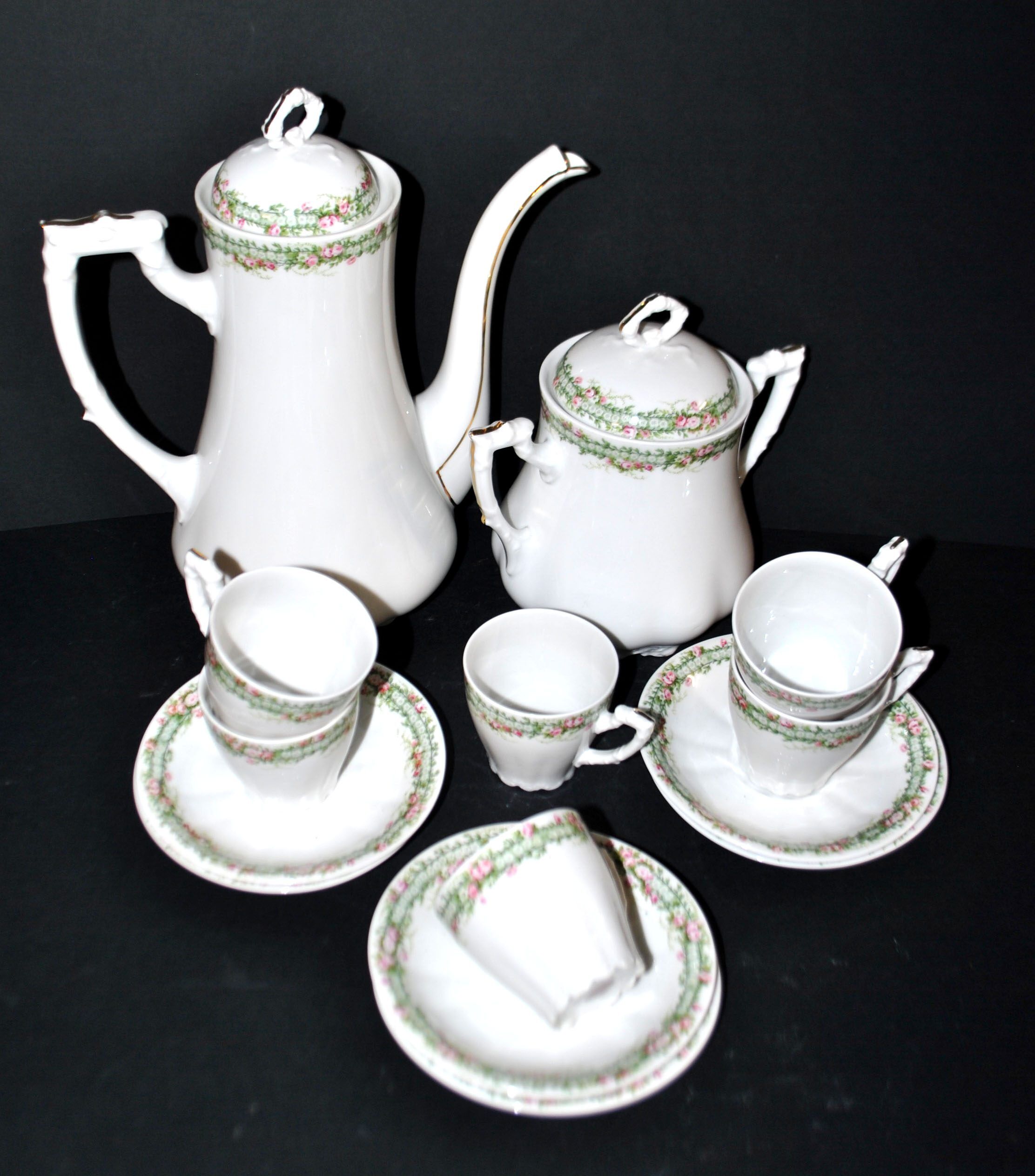 Vintage Limoges coffee service with pink and green floral decoration, coffee pot, sugar bowl, and 6 cups.