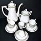 Vintage Limoges coffee service with pink and green floral decoration, coffee pot, sugar bowl, and 6 cups.