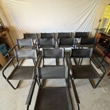 Set of 12 vintage chairs in black leather and tubular steel – Italy, 1970s